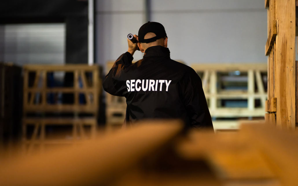 Security guard walking around construction site at night